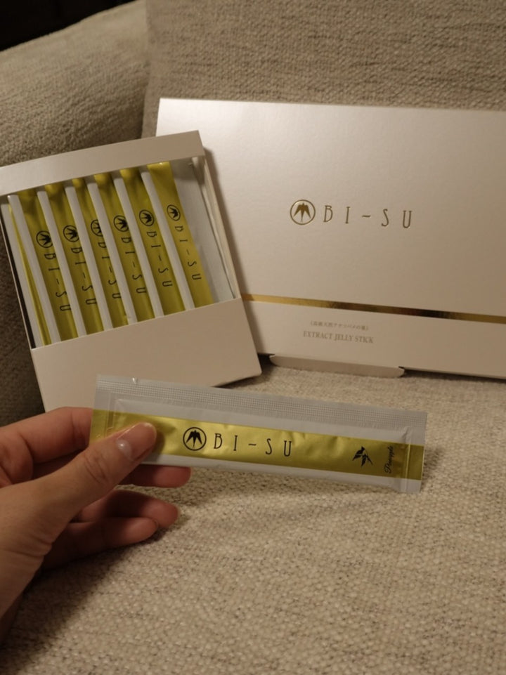 An open box of BI-SU jelly sticks on a linen sofa