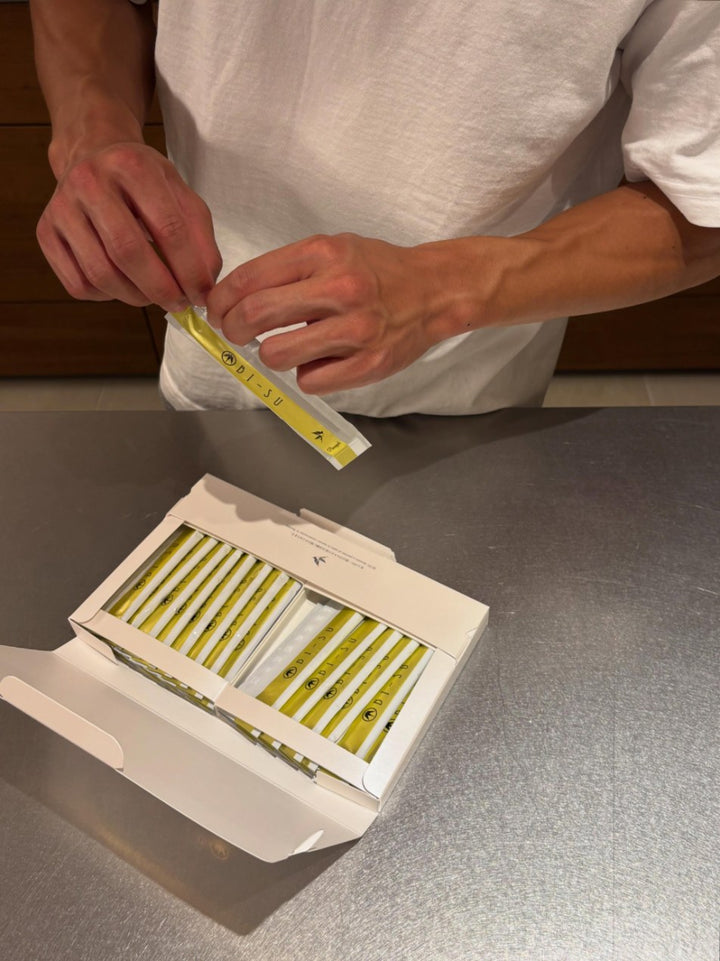 A man opening a BI-SU jelly stick over its open box