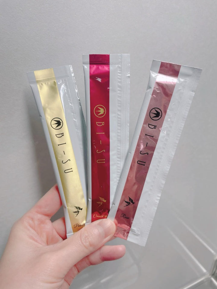 Pineapple, cranberry and rose BI-SU jelly sticks held in one hand