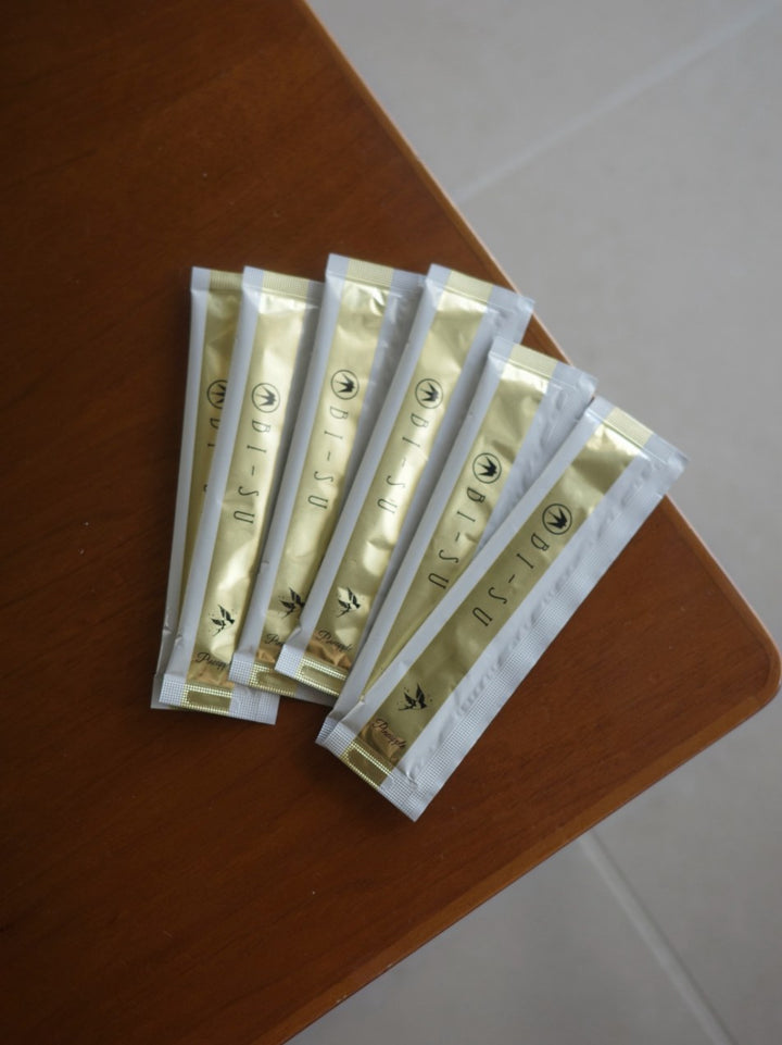 Six BI-SU jelly sticks fanned out on a wooden table